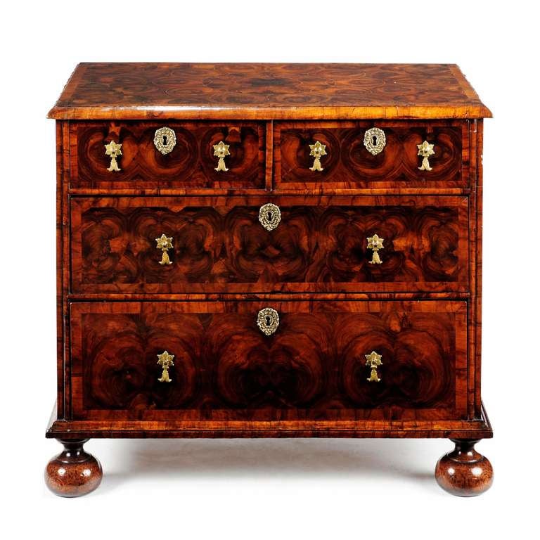 A superb William & Mary olivewood oyster veneered chest of compact proportions. The rectangular top laid with a central circular geometric pattern of cut oyster veneers bordered with inlaid boxwood stringing, with a heart shaped pattern to each