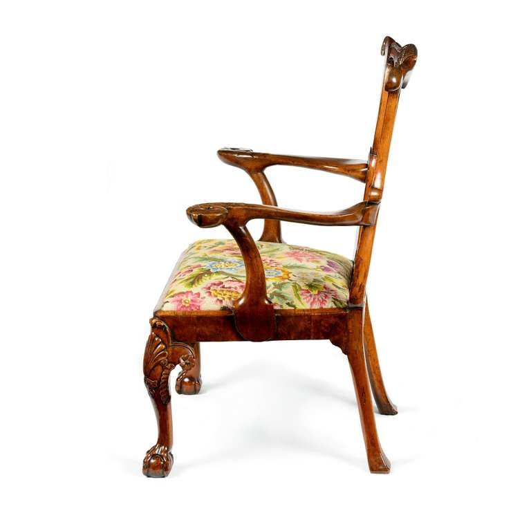 A superb, rare George I figured & carved walnut armchair retaining excellent colour and patina. The lyre shaped back of solid walnut and detailed with figured walnut veneers to the outer uprights. 

The top rail with central floral carved section,