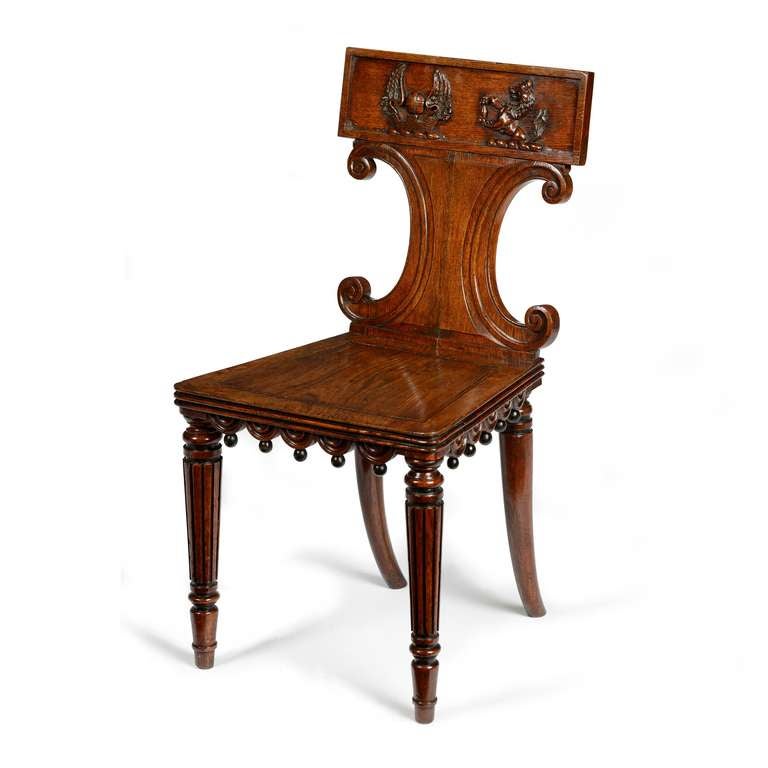 A pair of Regency brown oak hall chairs attributed to George Bullock