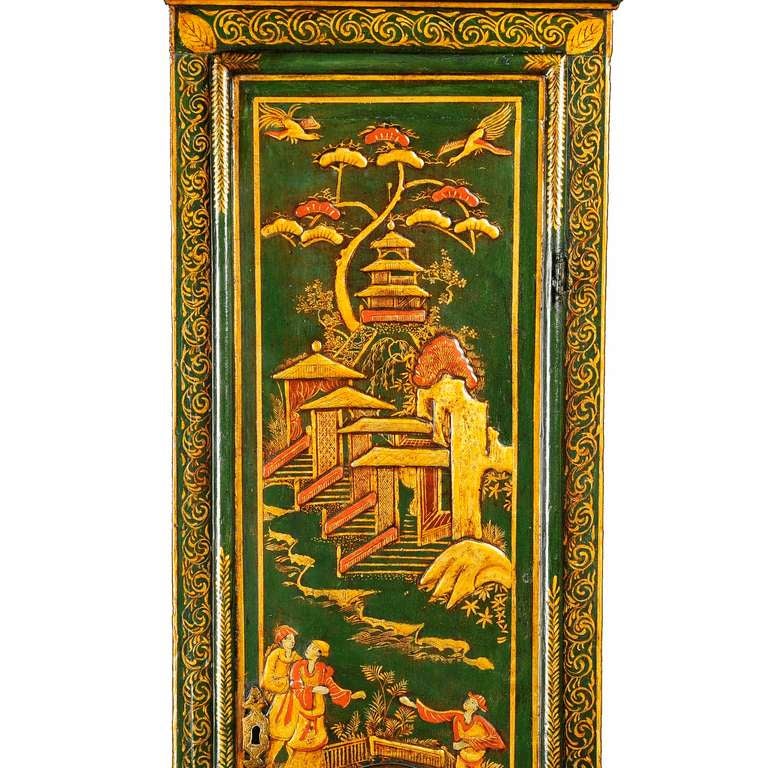 A fine George I green japanned, chinoiserie decorated eight-day longcase clock with lunar calendar by Edward Cockey, Warminster. The five finned pillar movement rack striking the hours on a bell. The 12” brass break-arch dial with calendar aperture