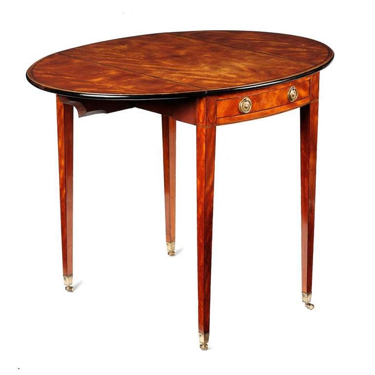 A fine English George III Sheraton period satinwood & tulipwood banded Pembroke table, of excellent compact dimensions, constructed of the finest West Indian satinwood veneers and retaining fine colour & patina. The oval figured mahogany top