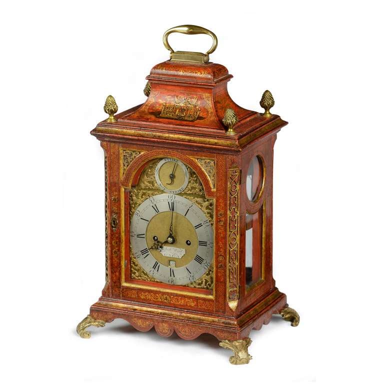 A superb George II red lacquer bracket clock by a very good London maker - Robert Ward. The inverted bell top case profusely and subtly decorated in the Chinese style, depicting scenes to the front and back of the top with further floral and trellis