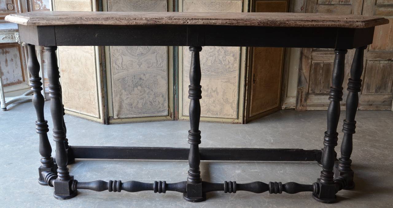 Grand 18th century console table with shaped patinated top supported by seven turned and carved legs,
Italy, circa 1790.