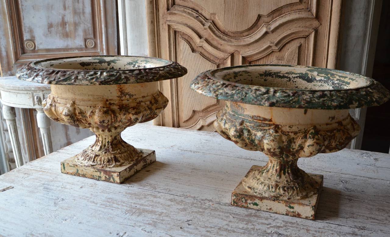 A pair of large 19th century cast iron urns Pair of 19th Century Cast Iron Urns
 with semi-lobed bodies, broad everted rims in an beautiful weathered patina.
France circa 1890