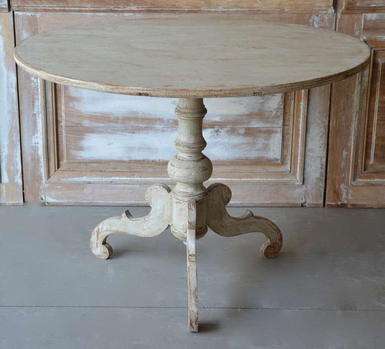 A large round top pedestal table, Sweden circa 1830 with turned base supported by beautifully carved legs. Scrape back to traces of its original color.