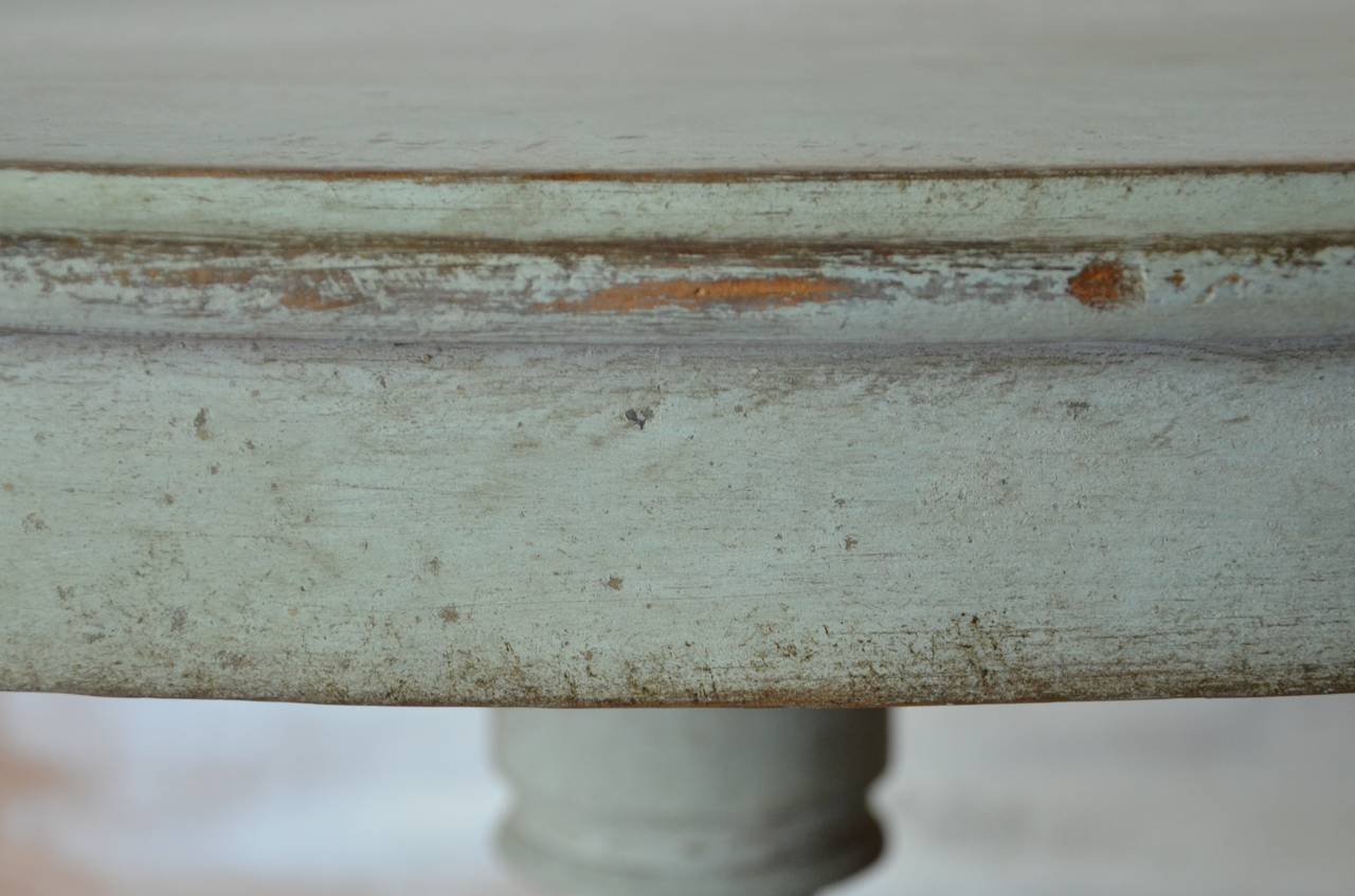 A charming pair of 19th century painted oval pedestal table with deep apron and turned base supported by beautifully carved legs in lovely pale blue patina.