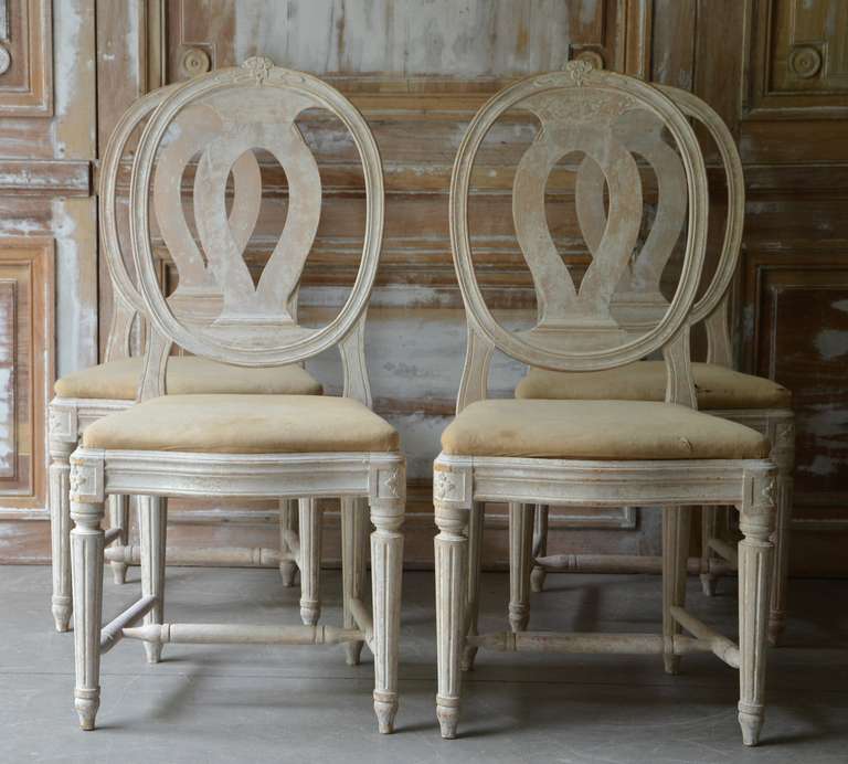 Set of Four 19th century Swedish Medallion Back chairs, circa 1880 in Gustavian style. Early Gustavian chair of the so-called äktsvenska model which has no equivalent in other countries. Carved rose with foliage on the back crest and turned,