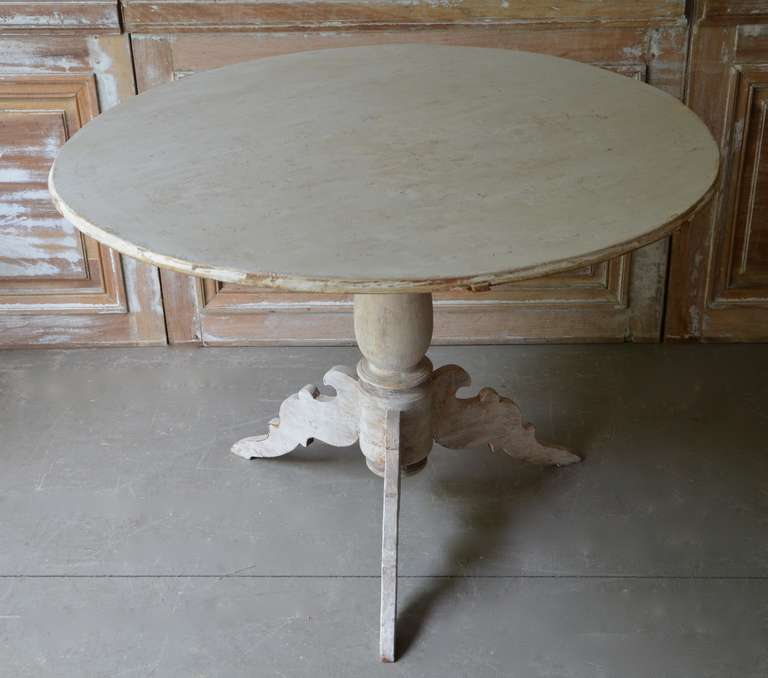 A large round pedestal tilt top table, Sweden circa 1850 with turned base supported by beautifully carved legs. Scrape back to traces of its original color.