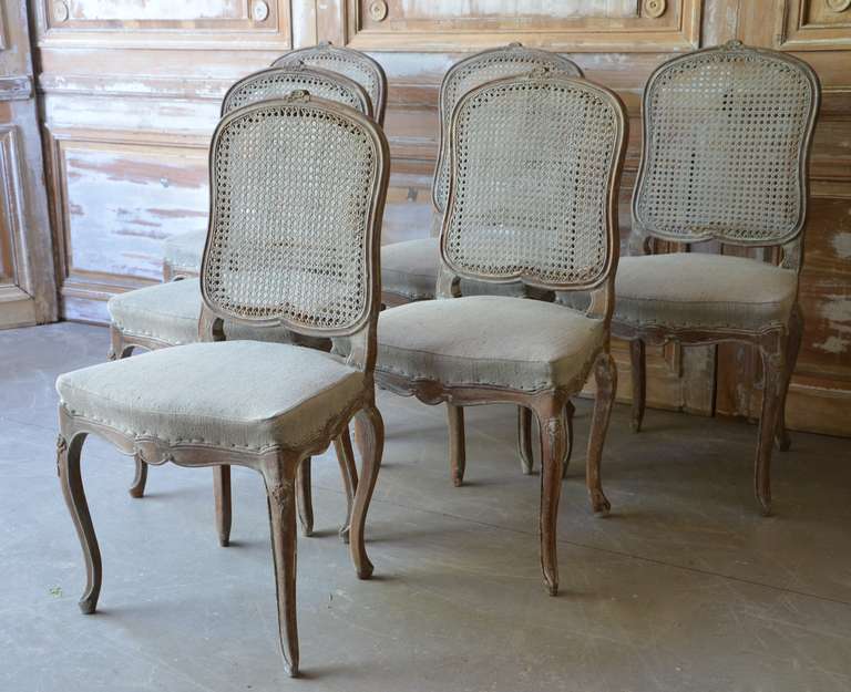 Set of six caned back French Louis XV style chairs in limed oak with traces of light blue paint. Seat covered with hand loomed palest blue linen.
France circa 1900