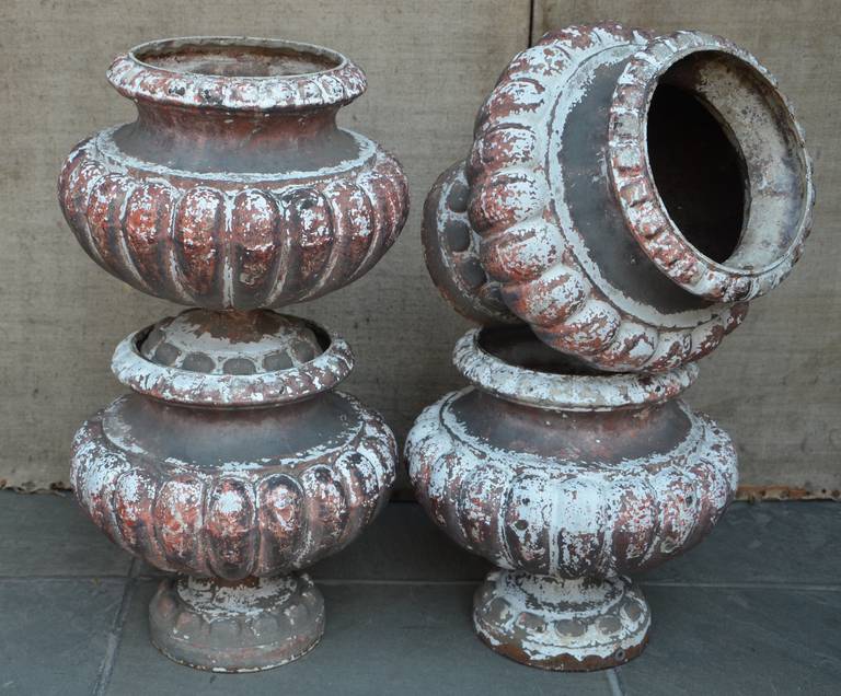 Set of Four 19th century French Cast Iron Urns with fluted contouring adding to the timelessness of these neoclassical show stoppers for the garden or your holiday decor.
France circa 1880

Can be decided in two pairs for $1900/pair