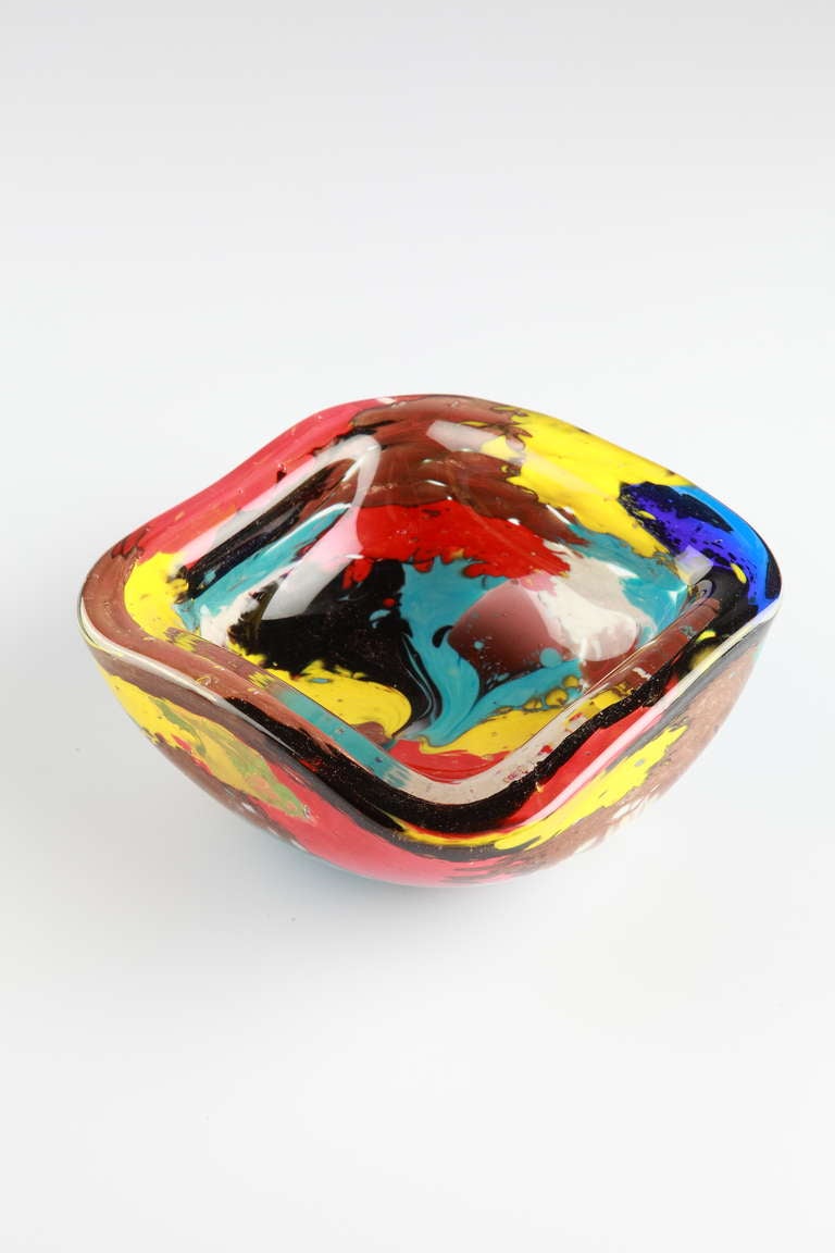 Multicolored glass designed by Dino Martens ( 1894-1970 ) for Aureliano Toso ( Murano )
Measures: Depth 5.2 in ( 13.21 cm ), Width 5.2 in ( 13.21 cm ), Height 1.97 in ( 5 cm )

Colorful Murano hand blown glass ashtray with aventurine flecks.