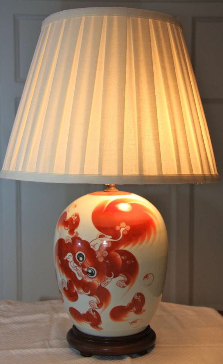 19th century Chinese porcelain melon jar with foo lion design in coral mounted as a lamp with a pleated shade