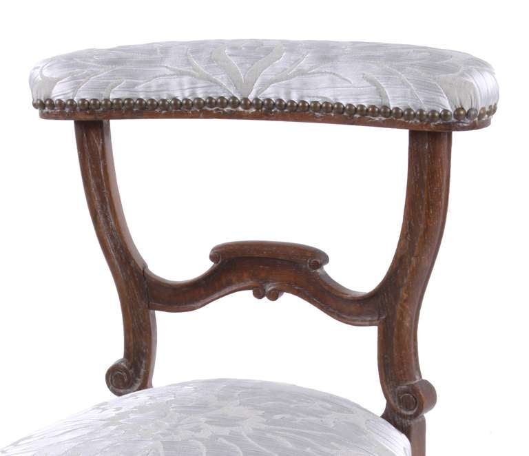 Louis Phillipe, 1870. A hand carved wood prie-dieu chair, once intended for prayer.  The toprail and seat have been newly upholstered in a gorgeous silver damask.  Nailhead trim provides a finishing touch.