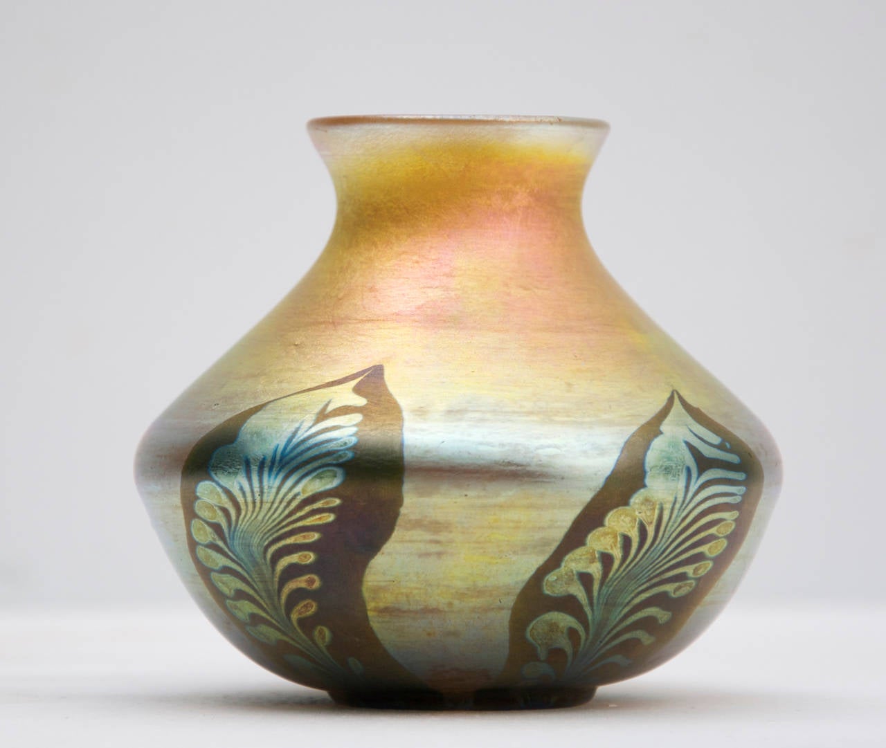 Fine quality Louis Comfort Tiffany Favrile glass vase with pulled feather decoration on gold iridescent body, button pontil, signed ‘L C Tiffany favrile V194’ circa 1904  Tiffany Studios, New York. Excellent condition.

Favrile glass was patented