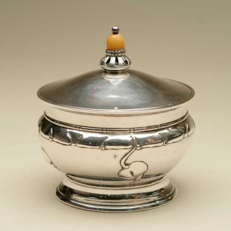 Featuring hand-chasing and magnolia designs with beautiful amber finial. Glass liner for easy serving and clean-up.