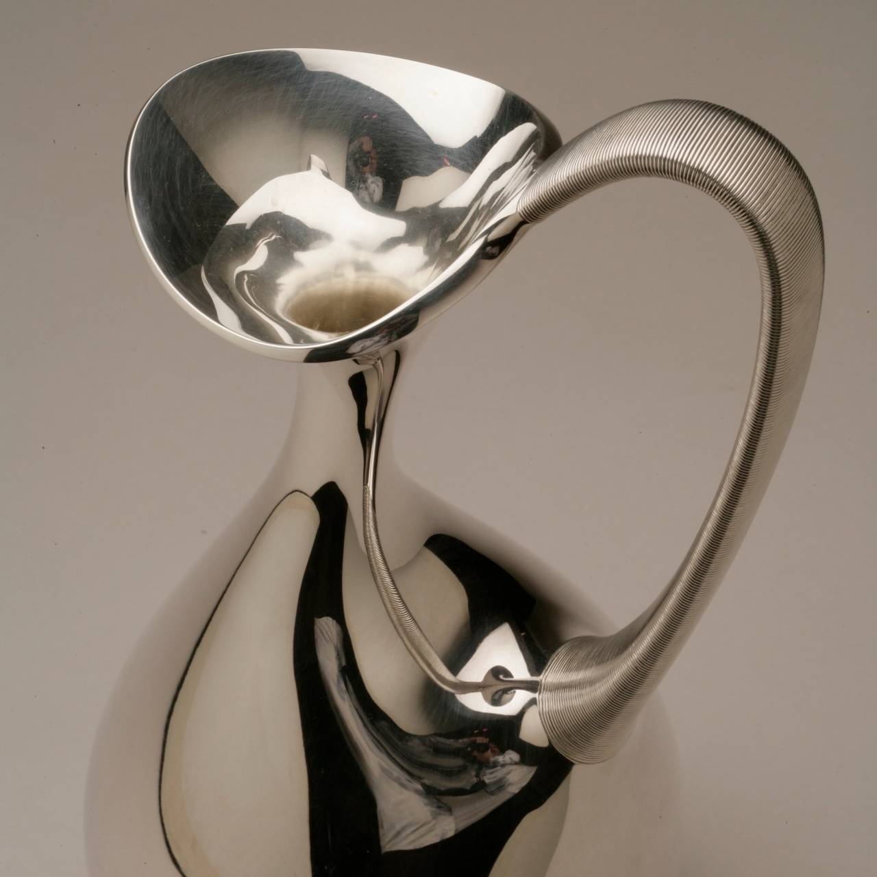 Georg Jensen sterling silver pitcher No. 978 by Henning Koppel. Large sculptural form water pitcher. Sensuous, elegant handle.

Designed in 1948. Awarded the Gold Medal at Triennale in 1951. 

Excellent Condition

Bio:

Henning