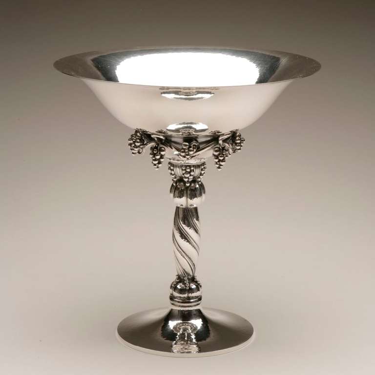 Georg Jensen Large Grape Compote, no. 264A.

Iconic example of Georg Jensen's superb design and attention to detail. Features a wide-rimmed bowl with dangling grape bunches atop a towering, stylized footed base. This is the second to the largest
