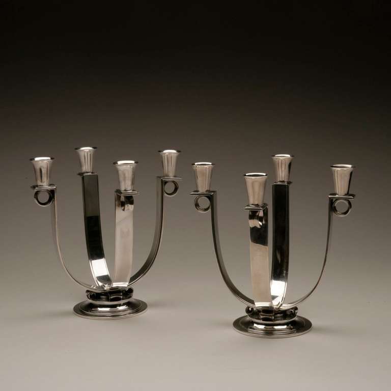 Georg Jensen very rare Art Deco candelabra, no. 623B.

Pair of four branch Art Deco rare candelabra designed by Oscar Gundlach-Pedersen in 1937. Features a sturdy, step-up base and strong and sleek arms topped with 