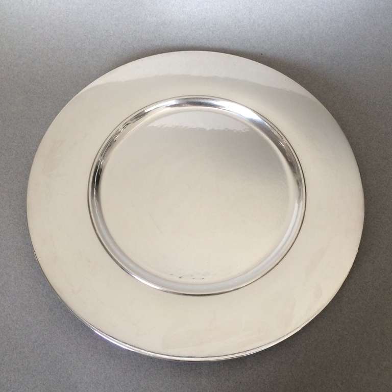 Georg Jensen complete set of 14 service plates No. 587C by Johan Rohde. 

Each one with a beautiful hand-hammered surface.

Rare to find in a large set, these 11