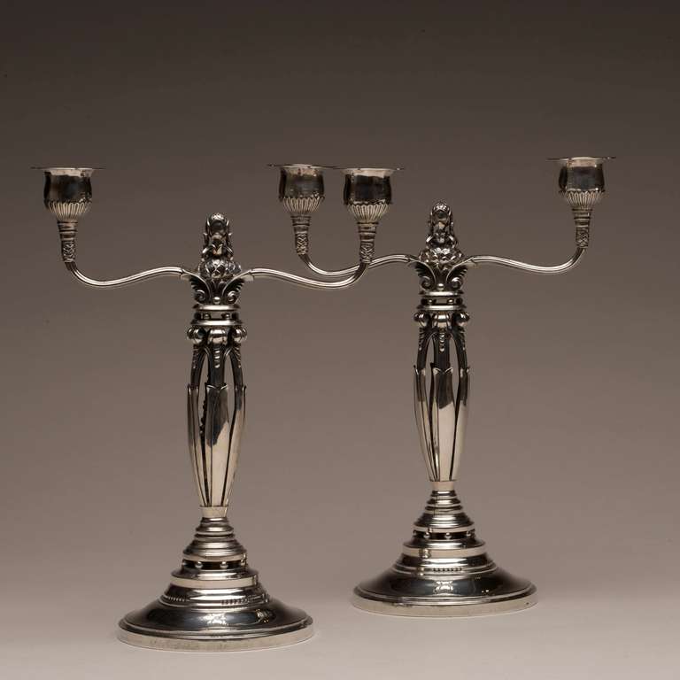 Georg Jensen candelabra 481A by Johan Rohde, very rare. Designed in 1927. Each on a circular, domed and stepped base, rising to an openwork berry and foliate stem, the reeded branches with fluted sockets and acorn central finial.

Dimensions: 12