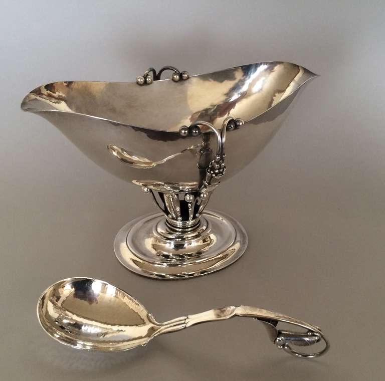 Georg Jensen extra large sauce boat No. 180. Beautiful sterling silver extra large sauce boat. Exceptional quality and detail. Hand chased and hand-hammered. Includes spoon no. 141. Dimensions: 9