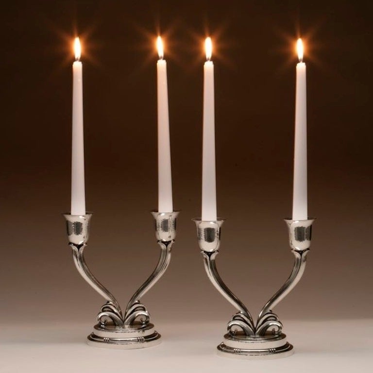 Evald Nielsen sterling silver pair of Art Deco candelabra.

Stunning sterling silver Art Deco candelabra. Exquisitely hand-wrought mounted on stylized scrolls and stepped base. Hand-hammered throughout. 
Handmade in Denmark at the Evald Nielsen