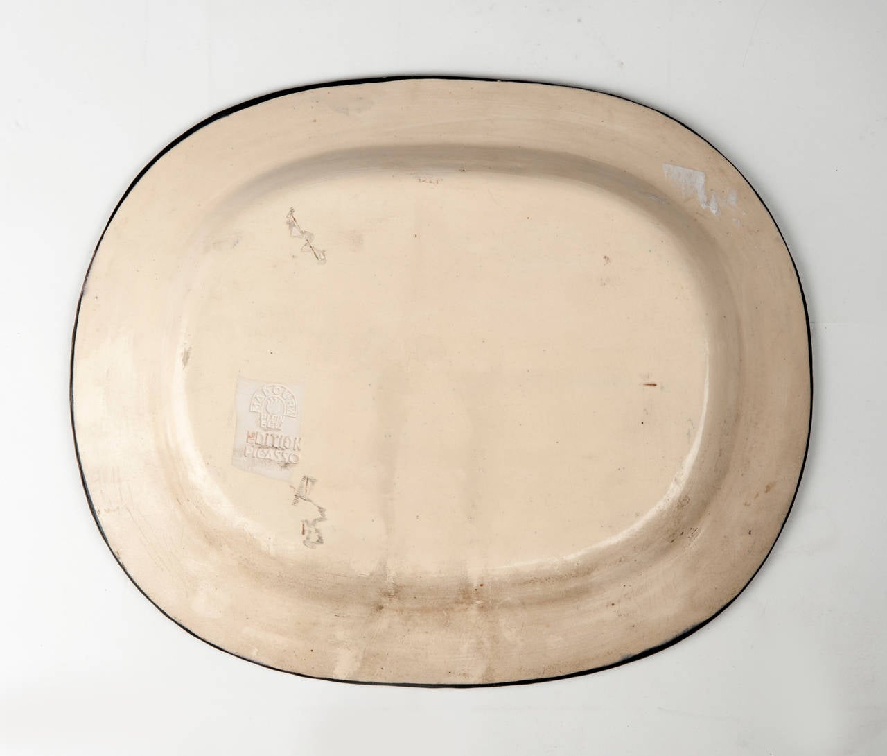 Pablo Picasso (1881-1973).
Nature morte (A.R. 219).
Stamped and marked 'Madoura Plein Feu/D'Après Picasso/Edition Picasso' (underneath). 
Partially glazed and engraved ceramic plate.
Length: 14 7/8 in. (37.8 cm.).
Conceived in 1953 and