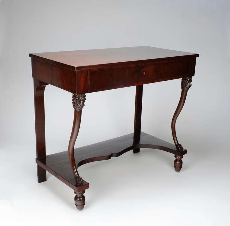 As one of America's leading cabinetmakers in the nineteenth-century, Duncan Phyfe defined American Neoclassicist Furniture.  This pier table with its defined lion's head carvings and slender elegant legs atop acorn feet is absolutely indebted to the