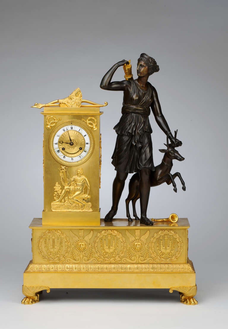 Dating to around 1830, this ormolu and patinated bonze clock is a fine example of its type. Forming a sculptural etude with its elegant composition, graceful proportions, and delicately wrought forms, the piece stands as a testament to the golden