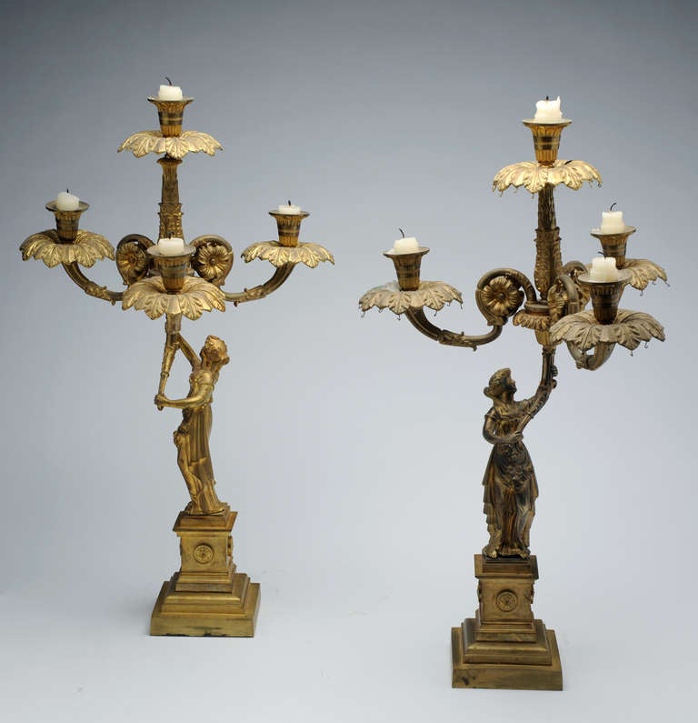 American Neoclassical Candelabra, c. 1835
Bronze
25 x 16 inches

Pair of finely cast and chased bronze Candelabrum in the form of classically draped female figures upholding torches with three radiating and one central candle-branch.