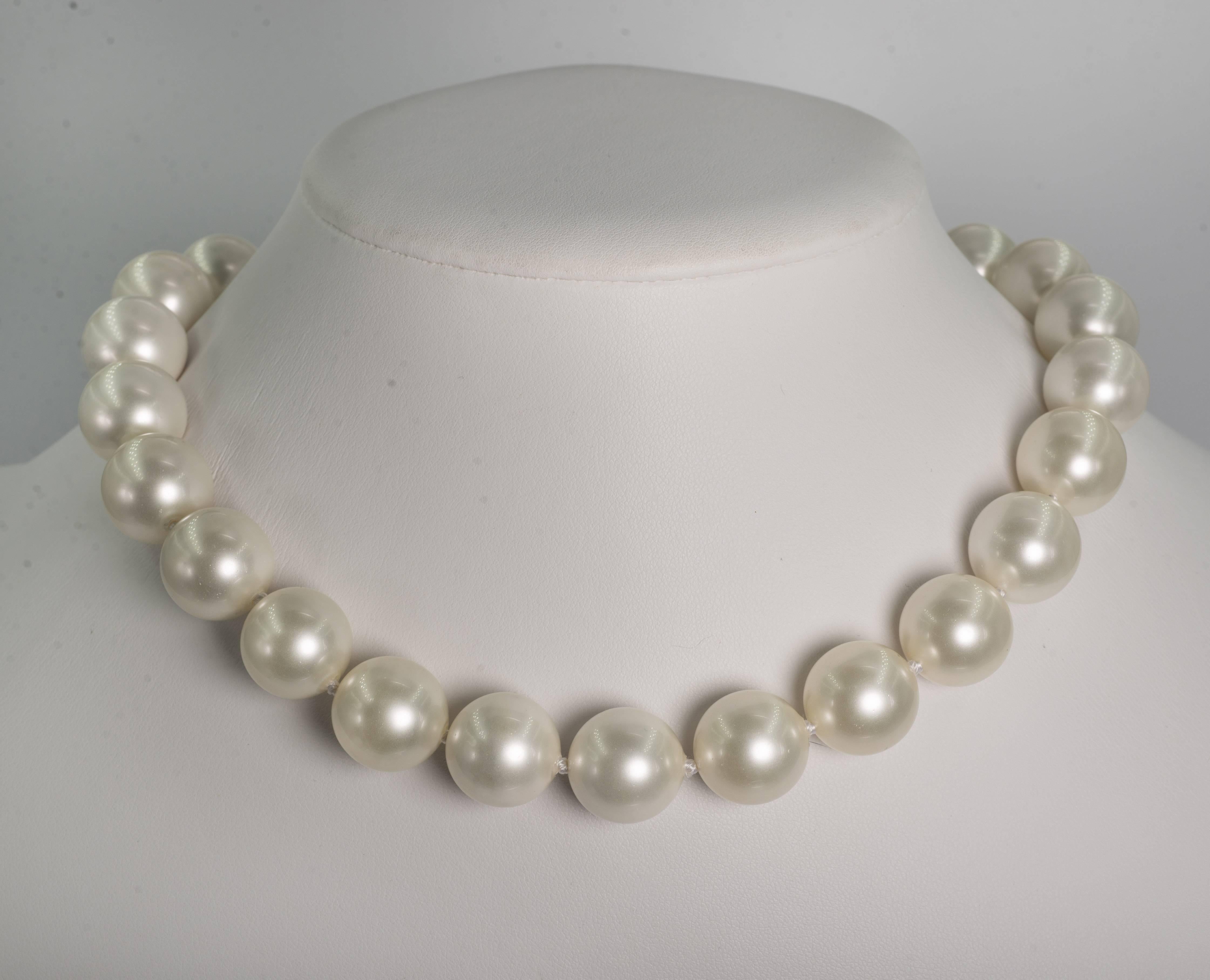 Faux 16mm South Sea Pearl Necklace measuring 18'' to a pave cubic zirconia clasp. The pearls are made of mother of pearl and have a wonderful luminescent pearl coating. Freshly hand strung knotted with silk threads.