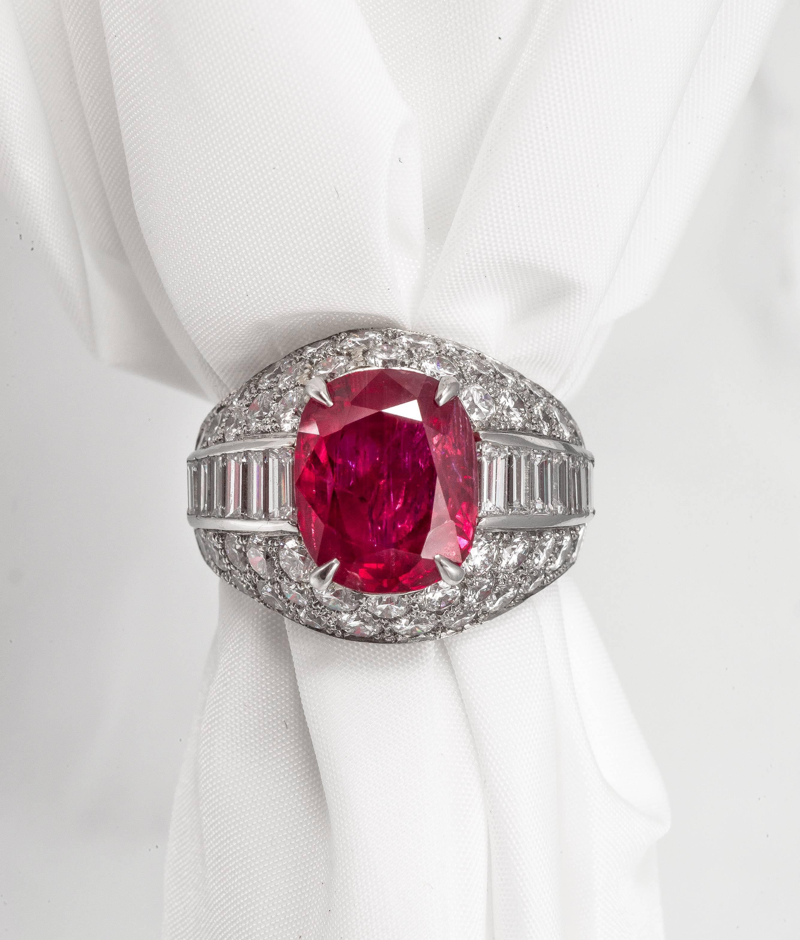 A truly stunning and classic Trombino ring, by Bulgari. 
Featuring a mixed cushion cut 5.98 ct Burma no heat ruby, surrounded by 4.40 carats of pavé set diamonds and baguette cut diamonds down the shoulders. 
Signed Bvlgari. 
Ring size 7.5
Ruby