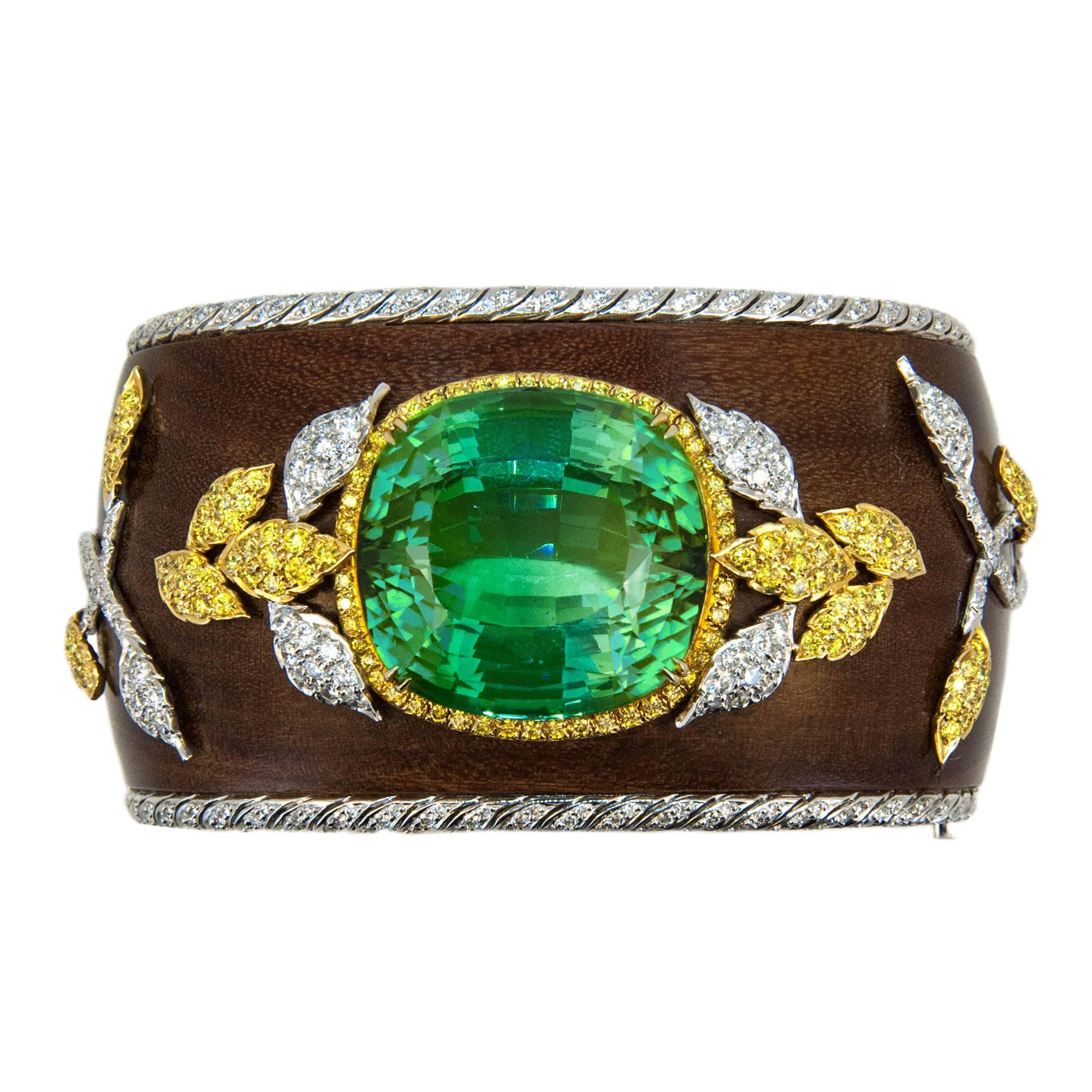 Artistically designed Fernambuk wood bangle bracelet created to showcase Exquisite Green Tourmaline. 18 karat white and yellow gold bangle bracelet, Fernambuk wood, 1 1/2" wide with rows of bead and bright set diamonds at edge. Bangle is set