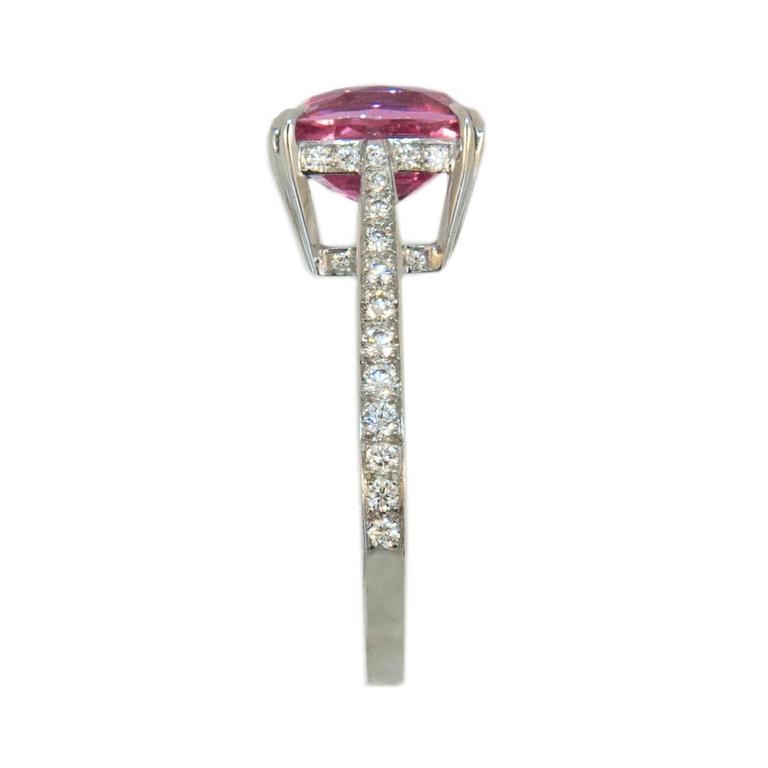 Delicious candy colored pink sapphire ring. Set in 18k white gold and diamonds. Set in center is one 3.53 carat rectangular cushion cut Pink Sapphire. Shank and underbezel are set with 48 round Diamonds .8 to 1.6mm weighing .37 carat total weight.