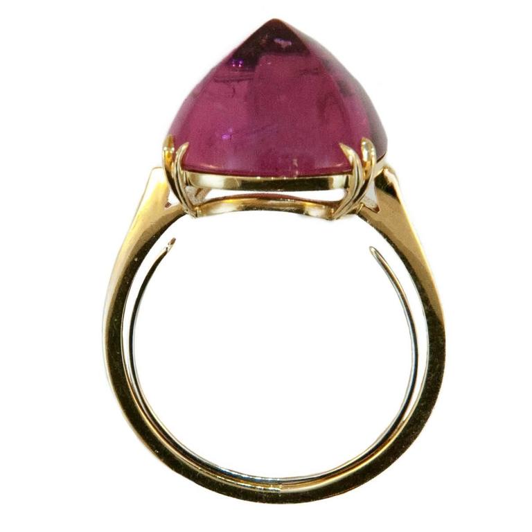 Fun Fashion ring with luscious pink color. 18k yellow gold ring set with one square cushion cut sugarloaf Rubellite Tourmaline 8.90cts. Double split prongs. Size 6.25 with sizing horseshoe. 