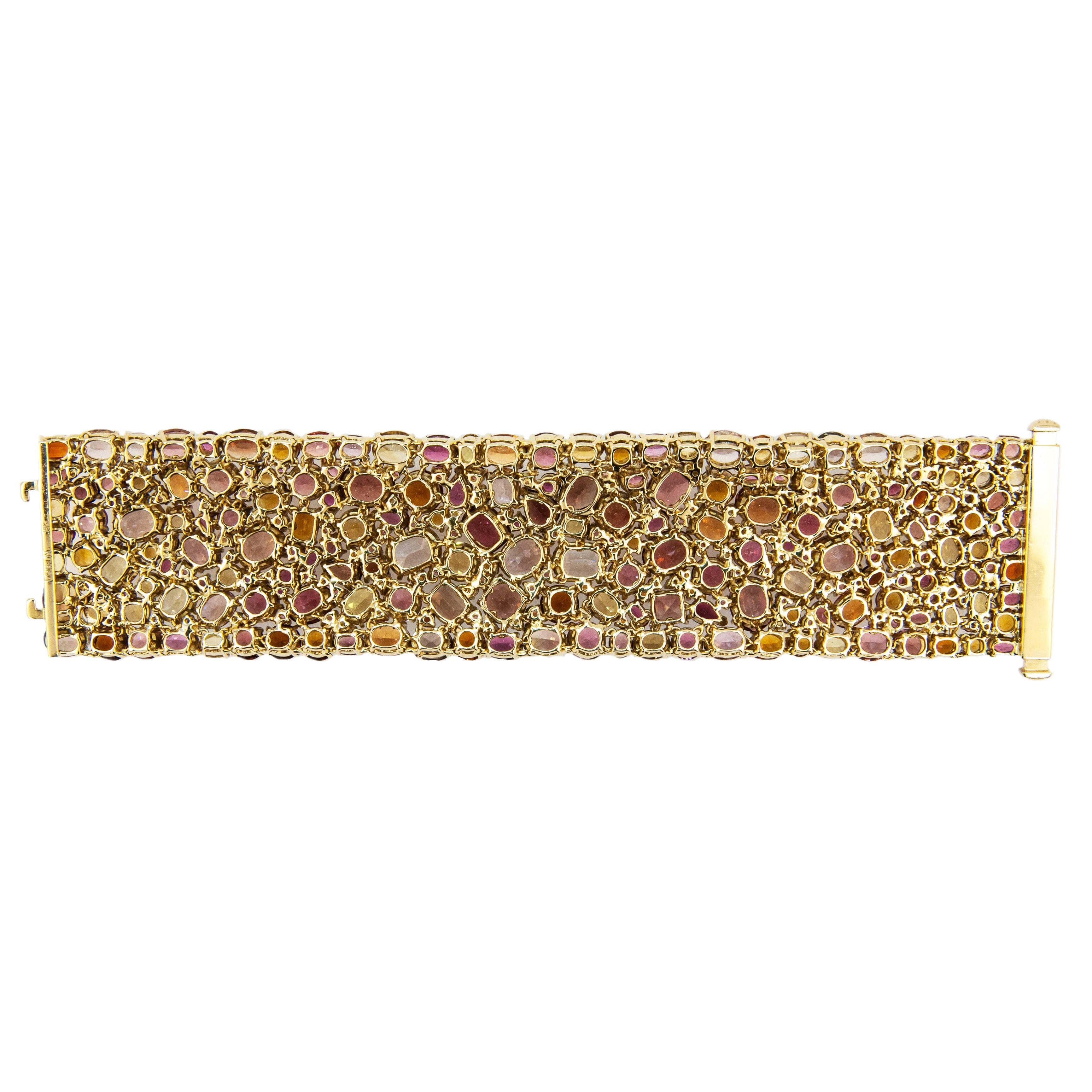 Magnificent 18k yellow gold Kaleidoscope bracelet. Set with 311 multi-colored, multi-shaped Citrine, Mandarin Garnet, Beryl, Garnet,Tourmaline and Sapphire. 173.62cts.twt. Shades of pink, yellow, orange and brown. 1 1/2" wide , 7 inch length.