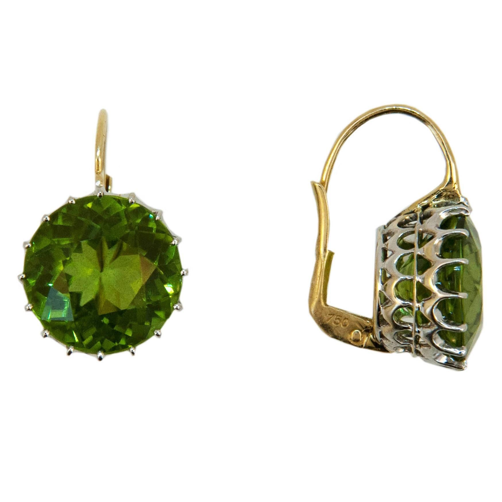 18 karat white gold and yellow gold wire earring round faceted Peridot 13.5 millimeters 18.44 carats total weight. Multi-prong white gold basket with yellow gold wires. Leverbacks.