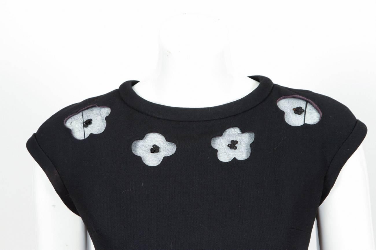 1970’s Courreges “Couture Future” black wool A-line evening gown with cap sleeves and floral cutouts at neckline. Cutouts are backed by stretch nylon with sequin detail at center flower. Fully lined, in excellent condition with one very hard to see