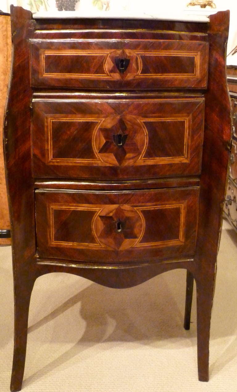An 18th century Italian Neapolitan inlaid and brass-mounted kingwood with marble top bedside cabinet.

 