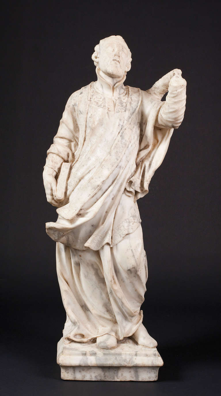 A late 17th century marble sculpture of a saint, possibly Central Italian. Monogrammed on the marble base 