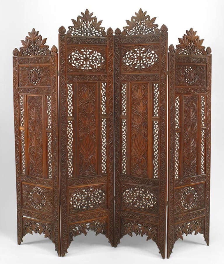 Moorish style carved and pierced teak 4 fold screen with floral filigree design and 2 tall center panels.
