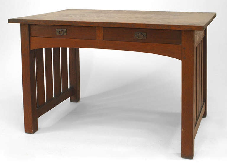 American Mission oak library writing table with rectangular top over 2 frieze drawers and square legs joined by slatted sides. (attributed to Onondaga Shops)
