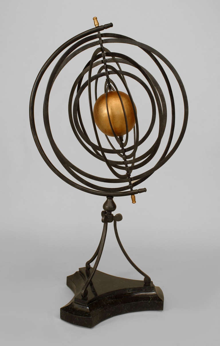 Twentieth century iron armillary sphere inspired by the the Copernican Model with nine concentric orbits centering a gold-painted sun above three legs and a tripartite marble base.