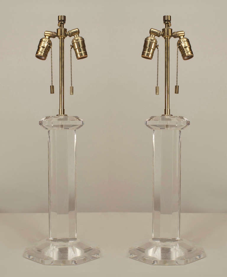 Pair of American 1960s Lucite table lamps with a large octagonal base supporting an 8-sided column (signed: KARL SPRINGER) (PRICED AS Pair).
