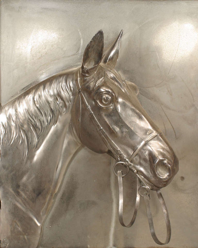 Pair of turn of the century English Country oak framed silver plate wall plaques, each depicting two horses gazing at each other in relief. The plaques bear a mark in their lower lefthand corners.