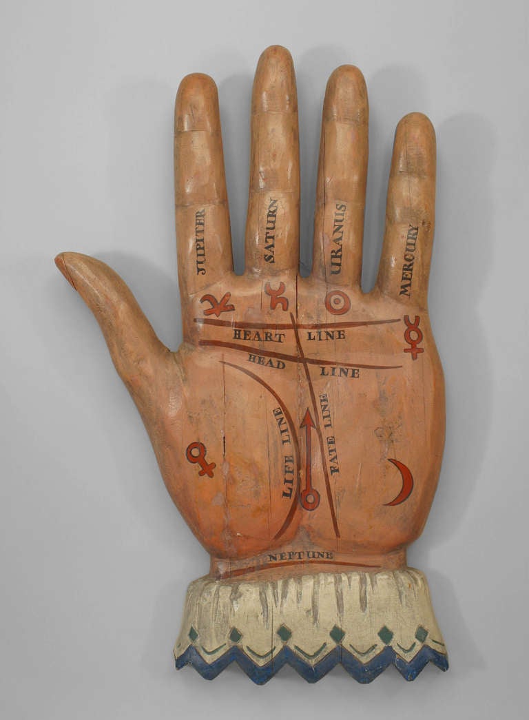 Large nineteenth century American Country palmist trade sign carved and painted in the form of a hand, wrist cuffed and palm outward, displaying various painted markings relating to palmistry and astrology.

For additional reference, please see