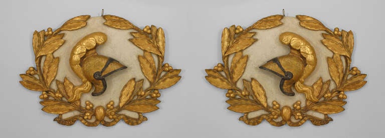 PAIR of Italian Neo-classic (18th Century) oval white wall plaques with a carved gilt helmet surrounded by a wreath (PRICED AS PAIR).