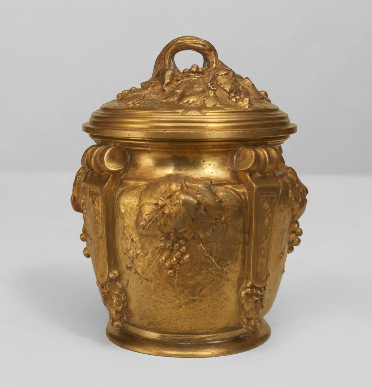 French Art Nouveau gilt bronze round box with 4 scrolls and a floral relief design with a cover (signed: MARIONNET)
