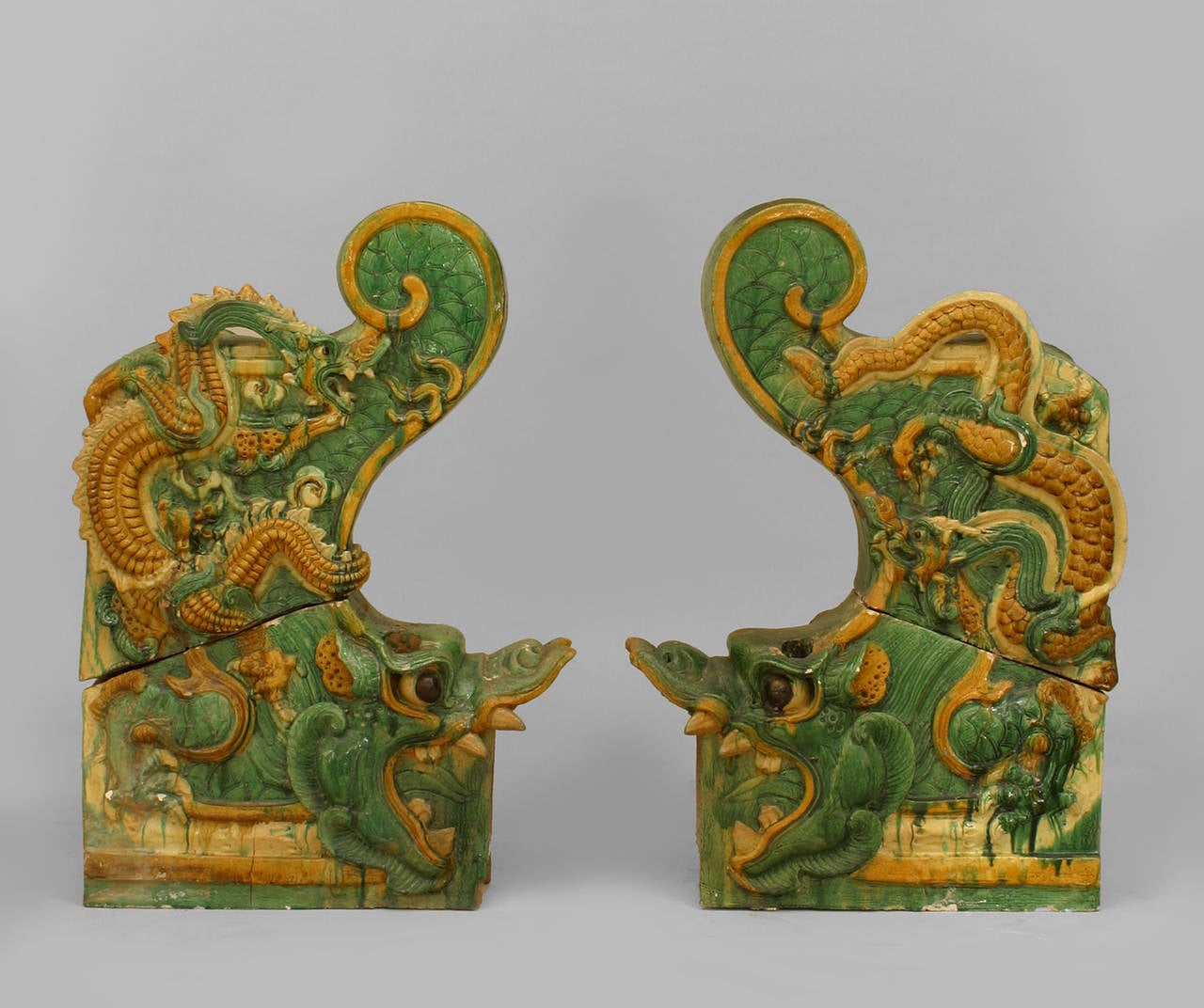 Pair of Chinese Ming dynasty, circa 1368-1644 C.E. green and yellow.
Glazed terracotta dragon left and right roof tiles, each composed of two pieces.