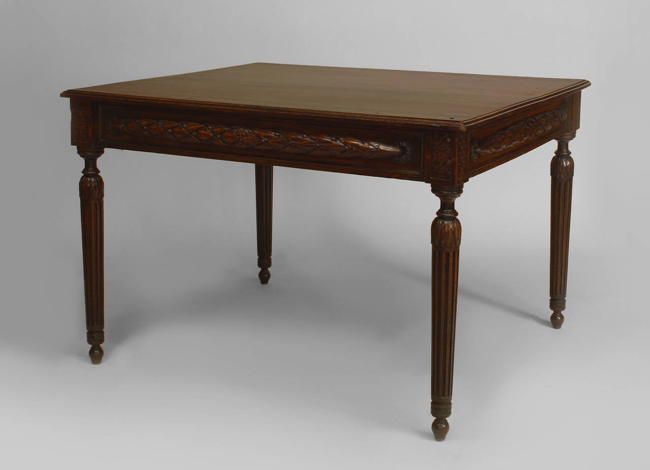 French Provincial (18th Century) walnut rectangular game table with carved wreath design apron supported on fluted legs.
